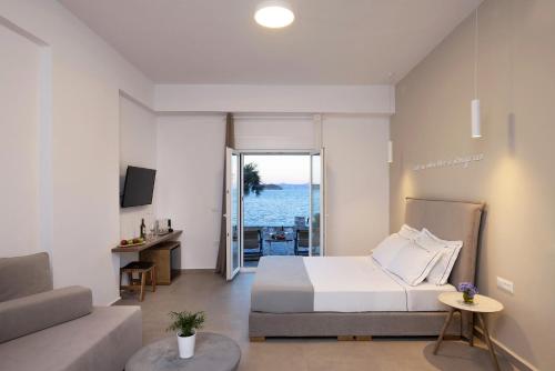 a bedroom with a bed and a view of the ocean at Vivianna's View in Azolimnos Syros