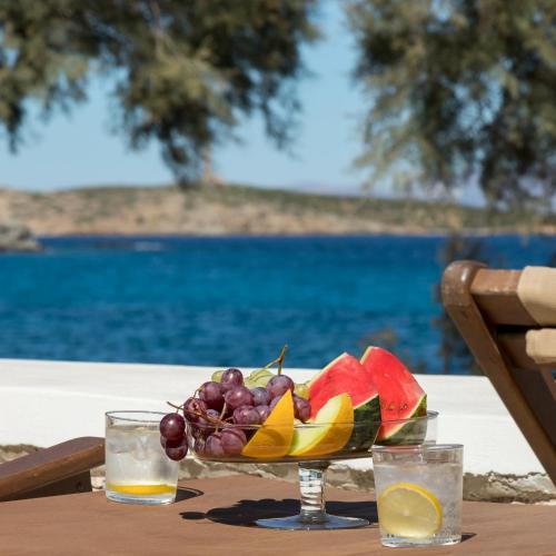 a bowl of fruit on a table with a drink at Vivianna's View in Azolimnos