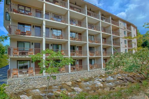 an apartment building on a hill with a river at Sidney James Mountain Lodge in Gatlinburg
