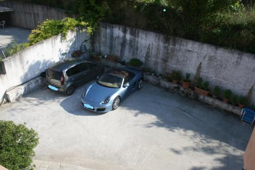 two cars parked in a parking lot next to a wall at Quality Suite, Tranquility, Sea Views, Breeze in Agios Gordios