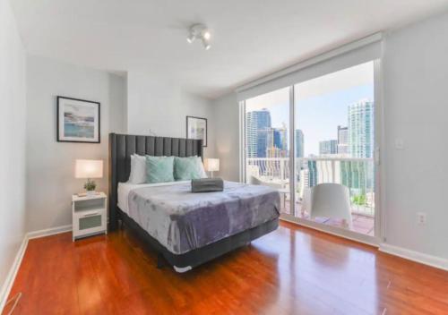 a bedroom with a bed and a large window at Exquisite Ocean View 3 BR Apartment in Miami