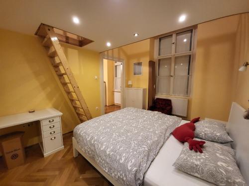 a bedroom with a bed with a red stuffed animal on it at M Apartments - Downtown 2 in Budapest