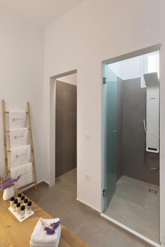 a bathroom with a glass shower in a room at Vivianna's View in Azolimnos