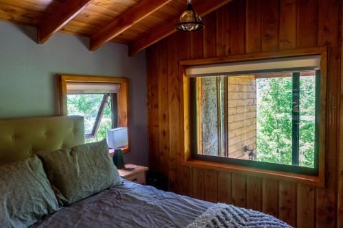 A bed or beds in a room at The GreeNest Lodge