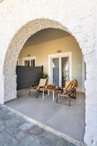 an archway with chairs and a table on a patio at Vivianna's View in Azolimnos