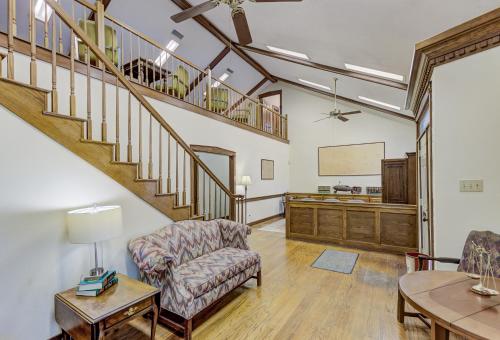 a living room with a staircase and a table at Halpino in Vicksburg