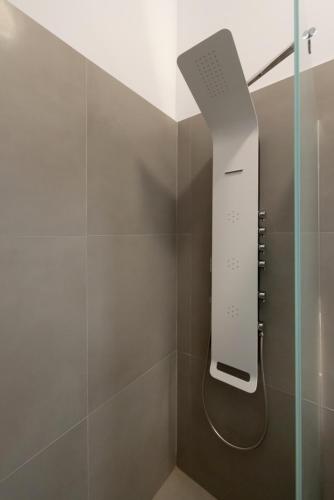 a shower with a glass door with a remote control at Vivianna's View in Azolimnos
