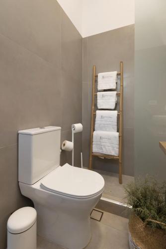 a bathroom with a toilet and a pile of towels at Vivianna's View in Azolimnos