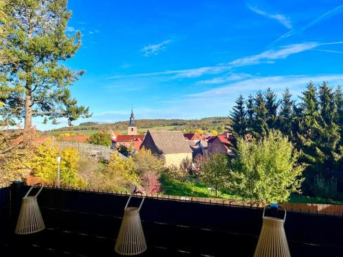 a view of a town from a balcony with two lights at Ferienhaus Harzblick in Meisdorf