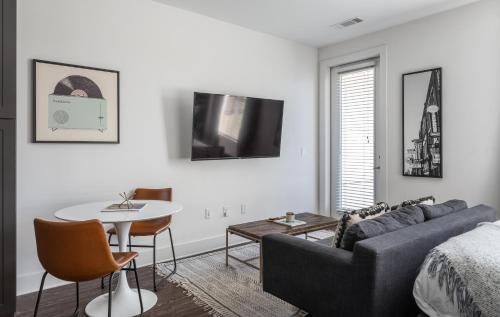 a living room with a couch and a table at Mint House Nashville - Music Row in Nashville
