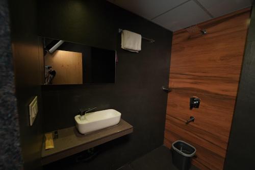 a bathroom with a white sink and a mirror at Southern Residency in Cochin