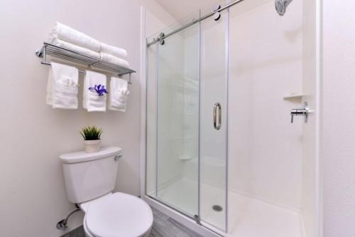 a white bathroom with a shower and a toilet at Holiday Inn Express & Suites San Diego - Mission Valley by IHG in San Diego