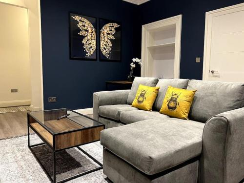 a living room with a couch and a coffee table at Modern Cotham House by Prescott Apartments in Bristol