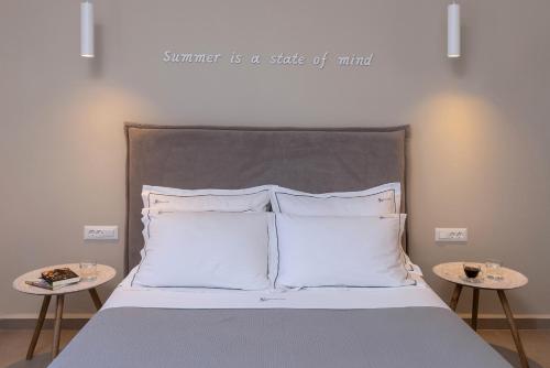 a bedroom with a bed with a sign above it at Vivianna's View in Azolimnos