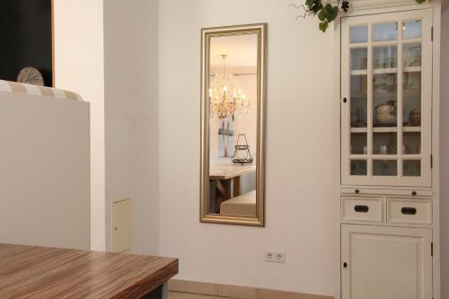 a mirror on a wall next to a kitchen at AvenidA Style Appartements by Alpin Rentals - incl Summercard in Kaprun