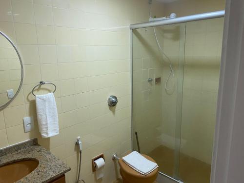 uma casa de banho com um chuveiro, um WC e um lavatório. em Apartamento Temporada Barra da Tijuca no Rio de Janeiro