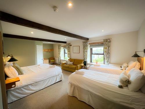 a bedroom with two beds and a living room at New Ing Lodge in Shap