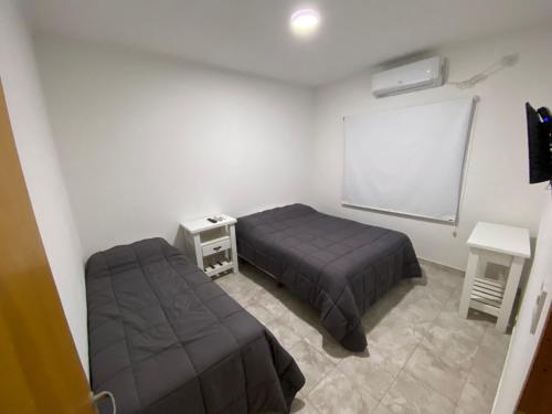 a bedroom with two beds and a chalkboard and a chalkoard at Don Benja in Federación