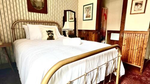 a dog sitting on a bed in a bedroom at Hotel La More at The Bisbee Inn in Bisbee