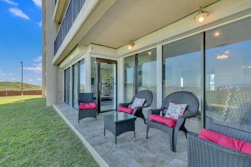 a patio with chairs and a table and windows at Sea Vista in South Padre Island