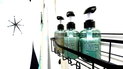 three bottles of detergent sitting on a rack at Hotel La More at The Bisbee Inn in Bisbee