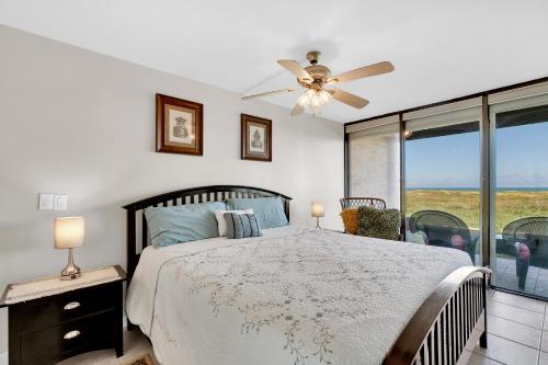 a bedroom with a bed and a ceiling fan at Sea Vista in South Padre Island