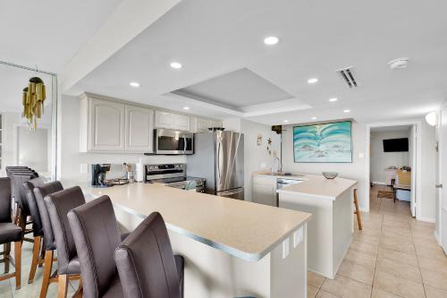 a kitchen and dining room with a table and chairs at Sea Vista in South Padre Island