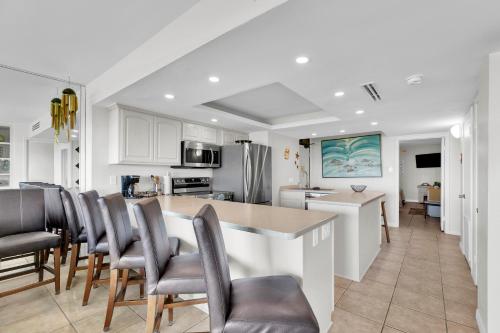 a kitchen and dining room with a table and chairs at Sea Vista in South Padre Island