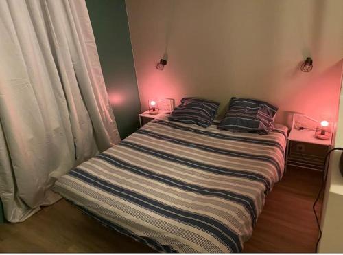 a bedroom with a large bed with two night stands at Détente au Centre-Ville - Lons-le-Saunier in Lons-le-Saunier