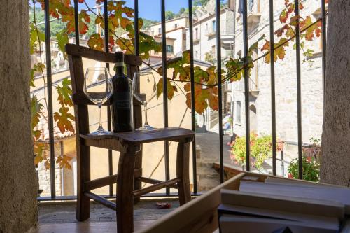 uma lâmpada numa cadeira de madeira numa varanda em B&B Sud e Magia em Castelmezzano