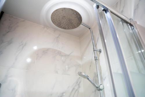 a shower with a shower head in a bathroom at Paris Homestay of Happyness in Le Kremlin-Bicêtre