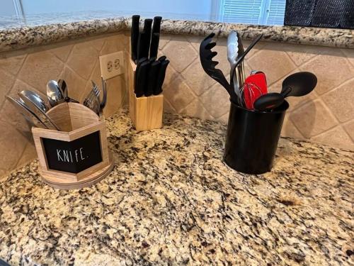 a counter with two containers of utensils on it at Home Away From Home-Cozy 2 BDRM Condo/Med Cntr/NRG in Houston