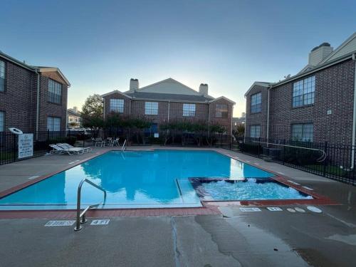 a large blue swimming pool in front of a building at Home Away From Home-Cozy 2 BDRM Condo/Med Cntr/NRG in Houston