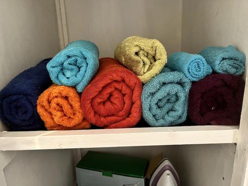 a shelf with a bunch of different colored towels at North Wales Holiday Accomodation with Free parking & WiFi in Bodelwyddan