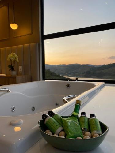 a bath tub with bottles of beer in it at Vista do Lago Hotel in Capitólio
