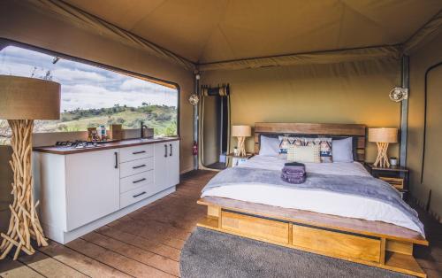 a bedroom with a bed in a tent at Sierra Escape Luxury Glamping in Piambong