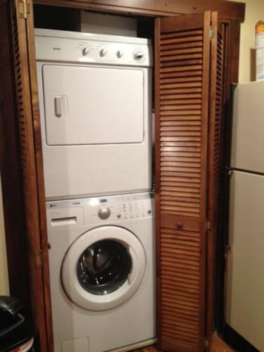 a washer and dryer in a kitchen with a refrigerator at KM Ranch Hideaway Cabin in Whitefish