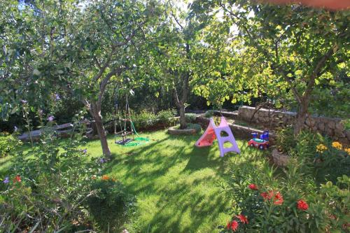 a backyard with a play set in the grass at Apartments for families with children Zdrelac, Pasman - 8424 in Ždrelac