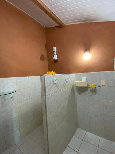 a bathroom with a shower with a glass door at Pousada Le Monte Cristo in Guaramiranga