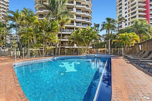 an empty swimming pool in front of a building at Aristocrat Apartments in Gold Coast