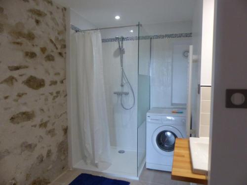a bathroom with a shower and a washing machine at Ferme éco-restaurée avec jardin, jeux enfants et parking près de Néris les Bains - FR-1-489-40 in Blomard