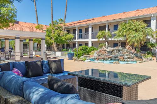 a couch in front of a building with a fountain at Venture on Country Club in Mesa