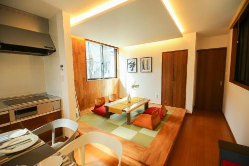 a kitchen and living room with a table and chairs at PrimeRoom Beppu TATAMIsuite in Beppu