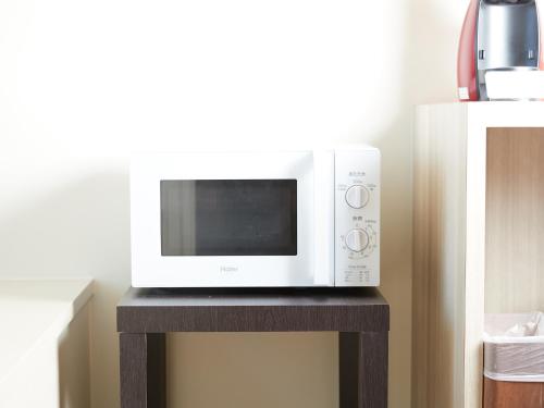 a microwave oven sitting on a table next to a appliance at Marea Resort Motobu in Motobu
