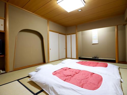 Ein Bett oder Betten in einem Zimmer der Unterkunft Yorozuya