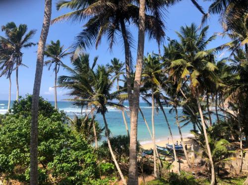 a view of the beach from a resort at SunRay Rest - Beach View Homestay in Mirissa