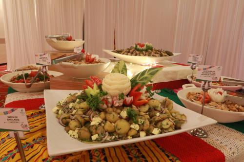 a table with several plates of food on it at Holiday Inn Tuxpan - Convention Center by IHG in Tuxpan de Rodríguez Cano