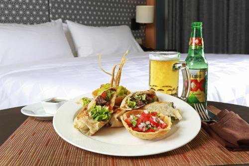 a plate of food on a table next to a bed at Holiday Inn Tuxpan - Convention Center by IHG in Tuxpan de Rodríguez Cano
