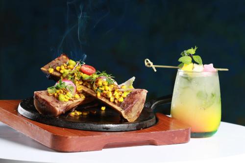 a plate of food on a table with a drink at Holiday Inn Tuxpan - Convention Center by IHG in Tuxpan de Rodríguez Cano