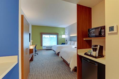 a hotel room with two beds and a television at Holiday Inn Express Campbellsville by IHG in Campbellsville